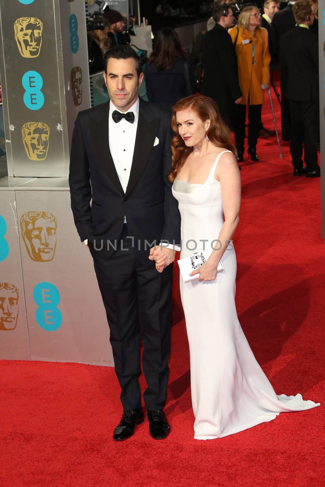 UK, London: Australian actress Isla Fisher poses with husband Sacha Baron Cohen on the red Carpet at the EE British Academy Film Awards, BAFTA Awards, at the Royal Opera House in London, England, on 14 February 2016.