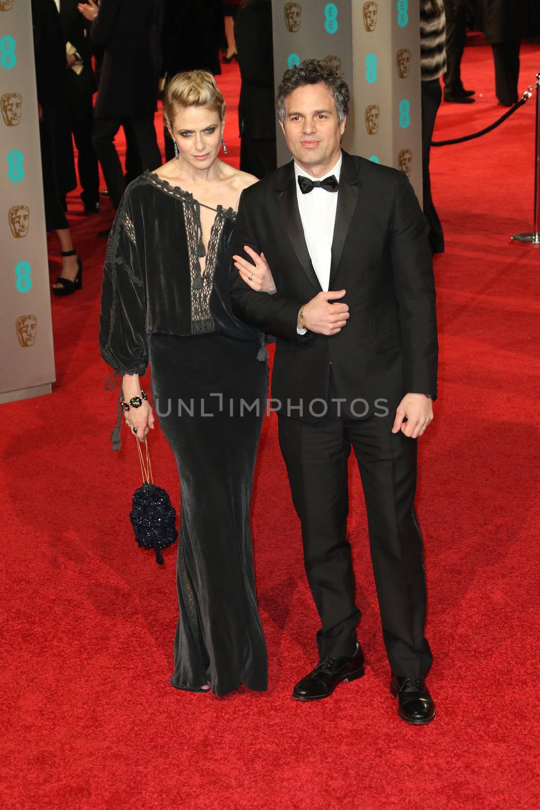 UK, London: American actor Mark Ruffalo poses with wife Sunrise Coigney on the red Carpet at the EE British Academy Film Awards, BAFTA Awards, at the Royal Opera House in London, England, on 14 February 2016.
