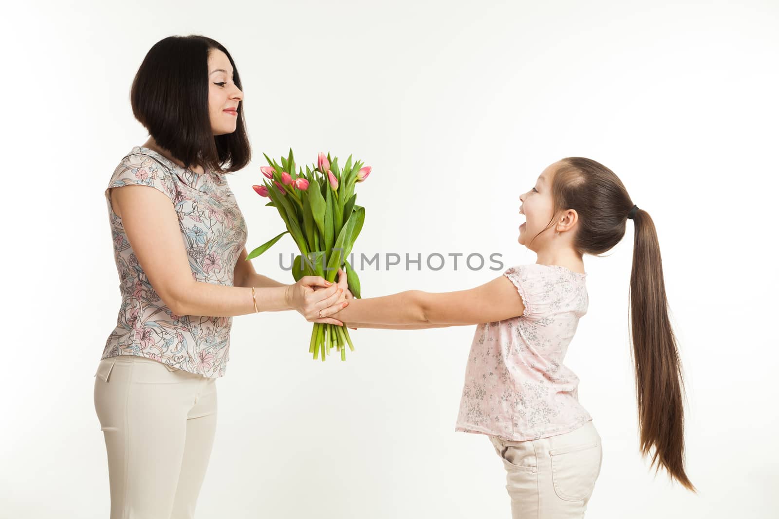 the girl gives to mother a bouquet of flowers