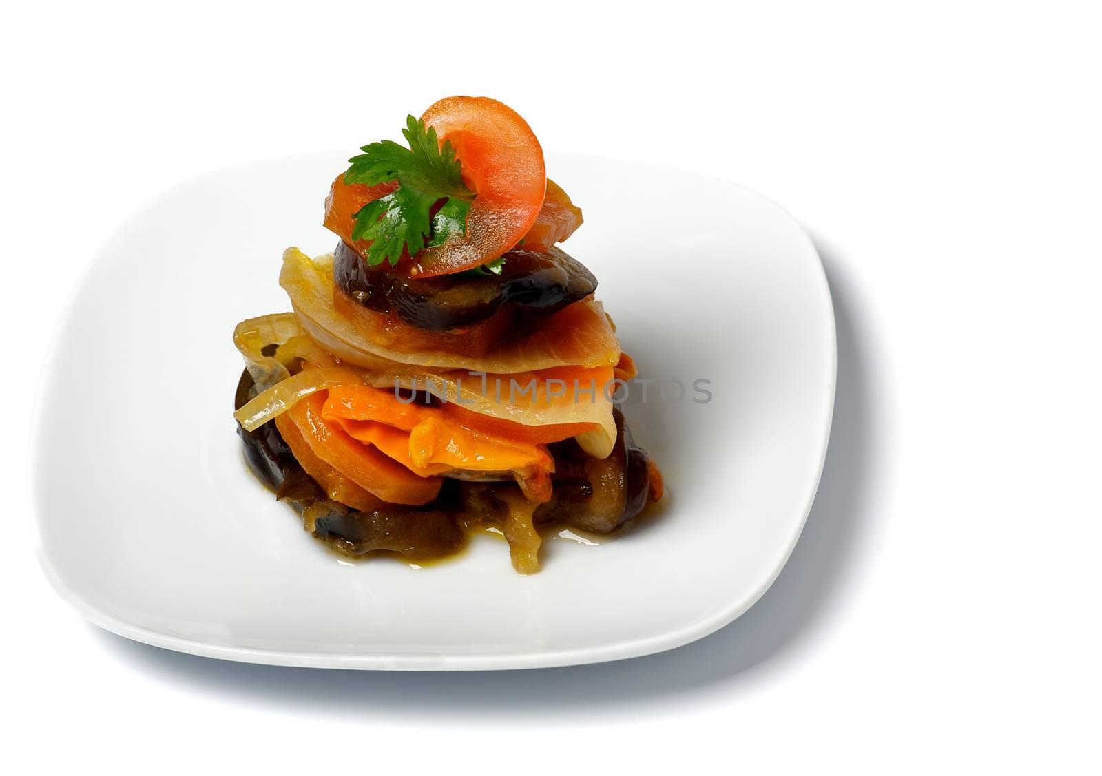 Stack of Homemade Vegetable Ratatouille on White Plate isolated on White background