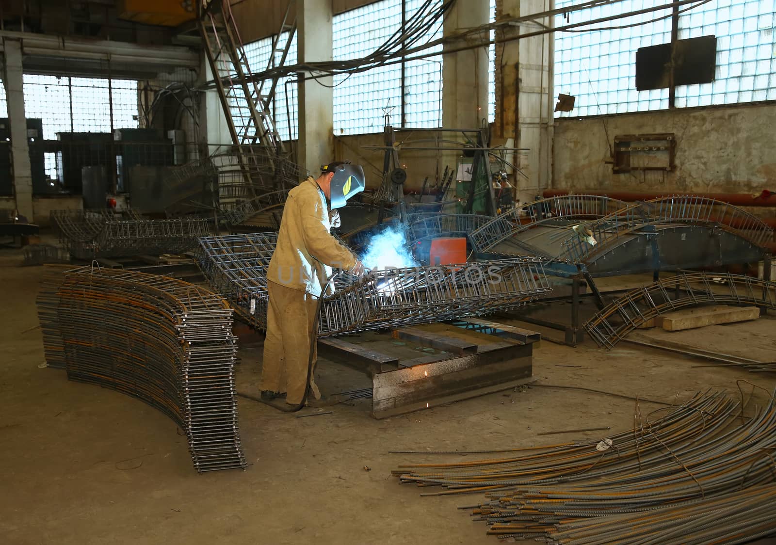 Welder in factory. A worker welds the valve by sergasx