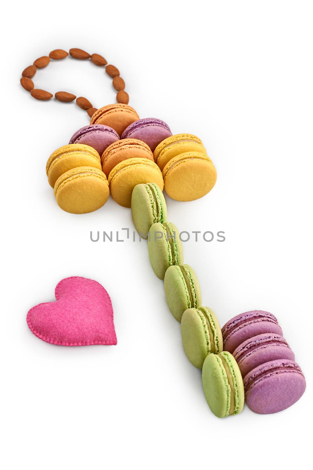 Macarons sweet colorful, key shape. Love, handmade hearts. French traditional delicious dessert, almond. Unusual creative romantic still life. Concept for love story. Valentines Day. Isolated