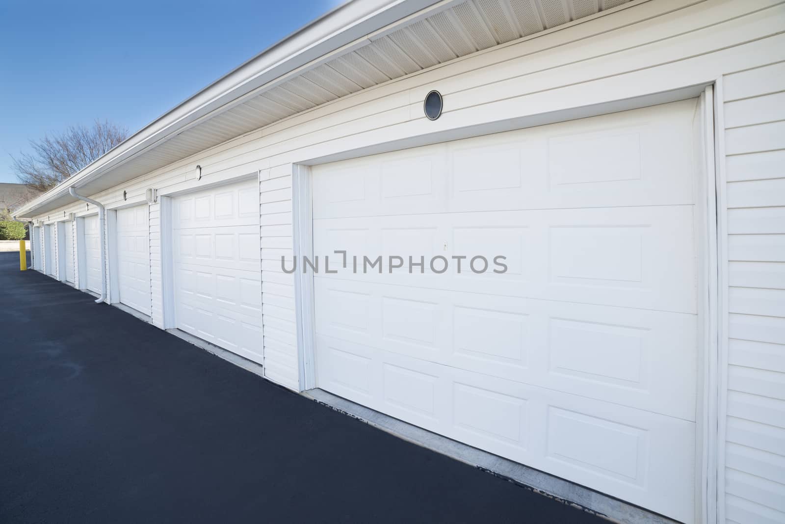 Row of garage doors at parking area for apartment homes by stockbuster1