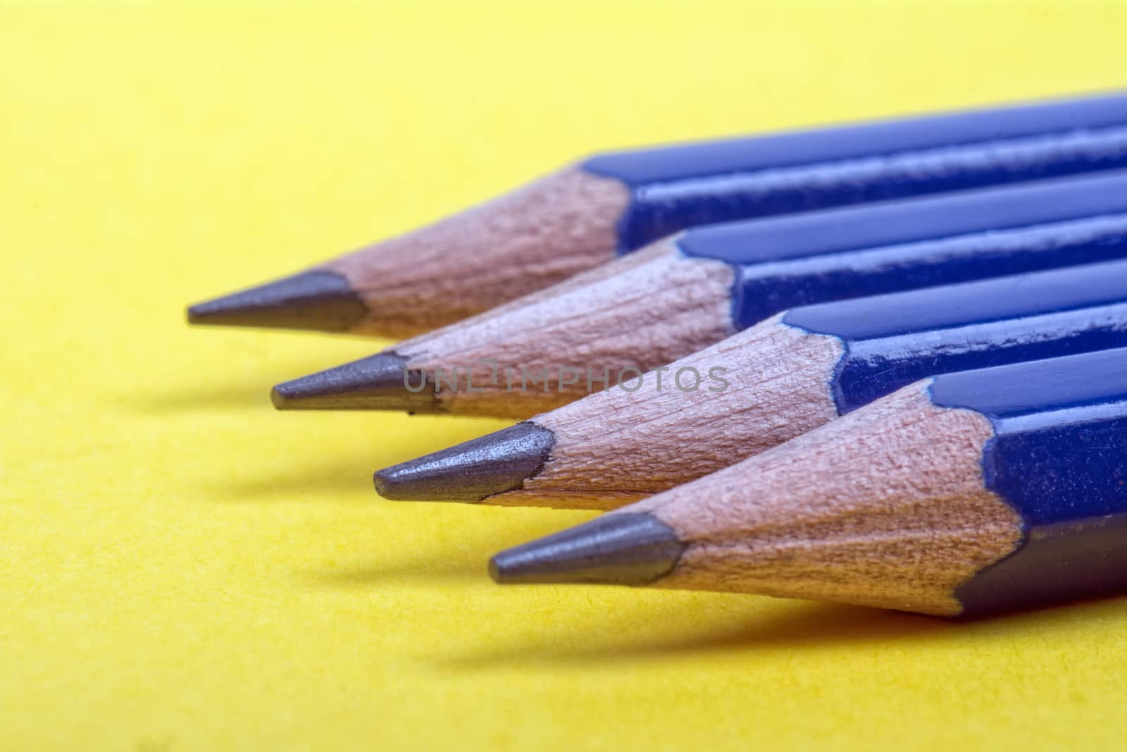 Four pronged pencils on yellow background