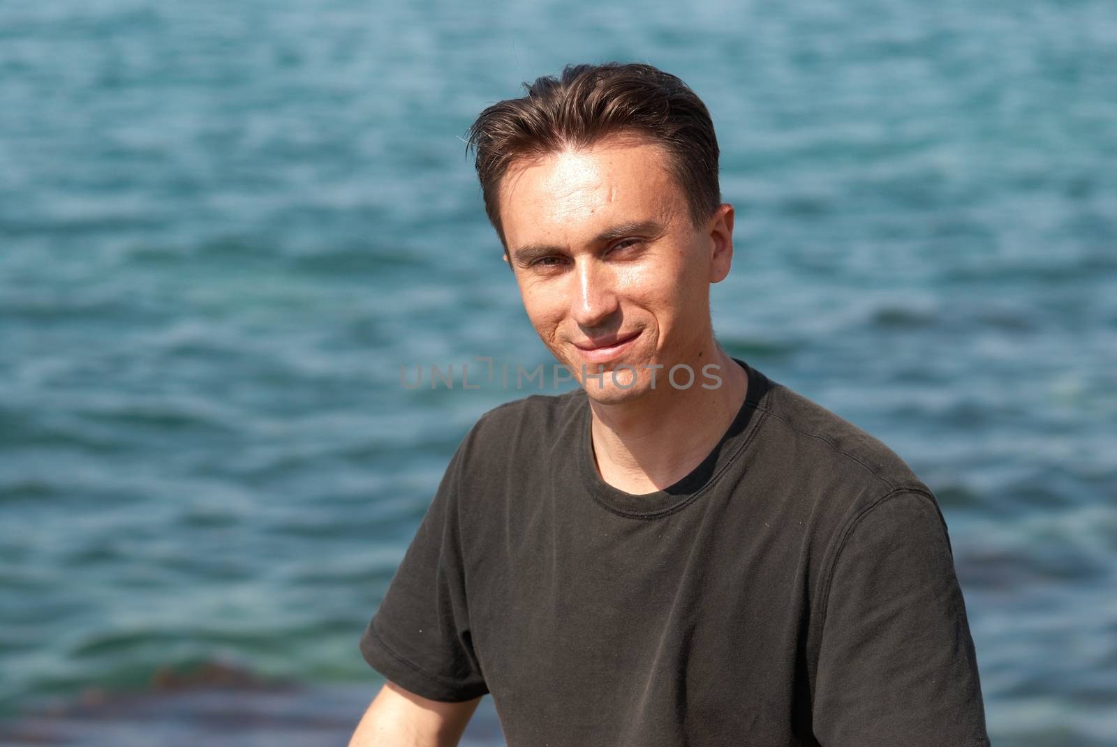 Portrait of young man with soft sea background