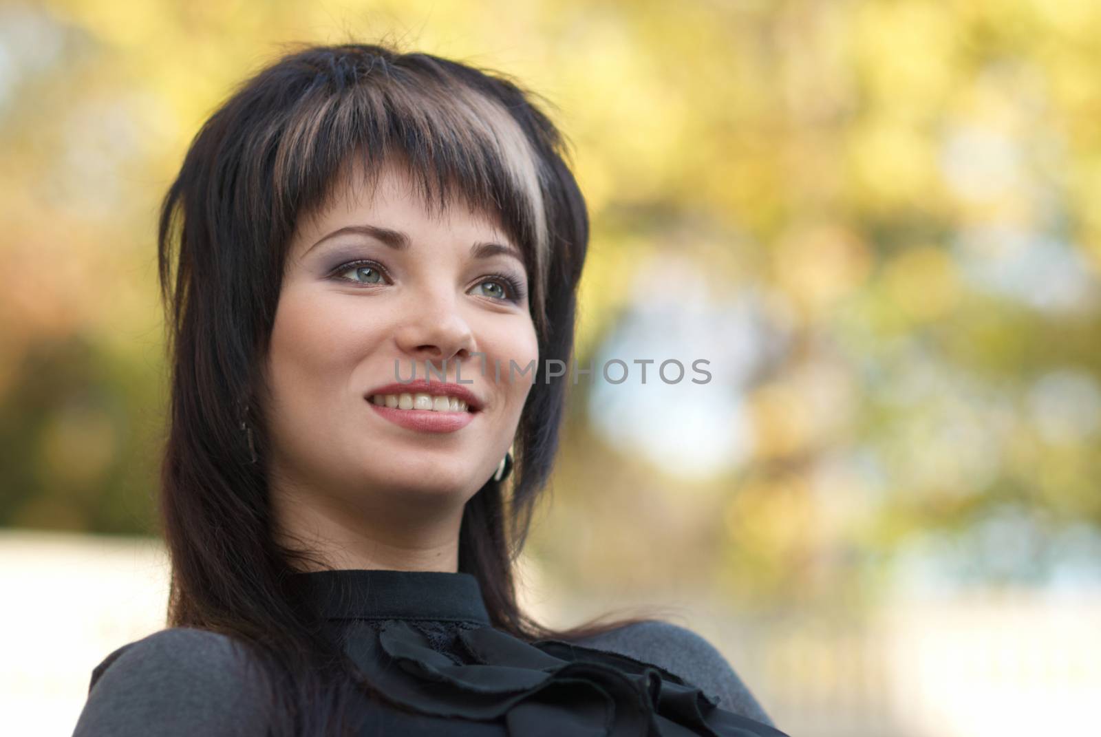 Beautiful girl's portrait with soft autumn background