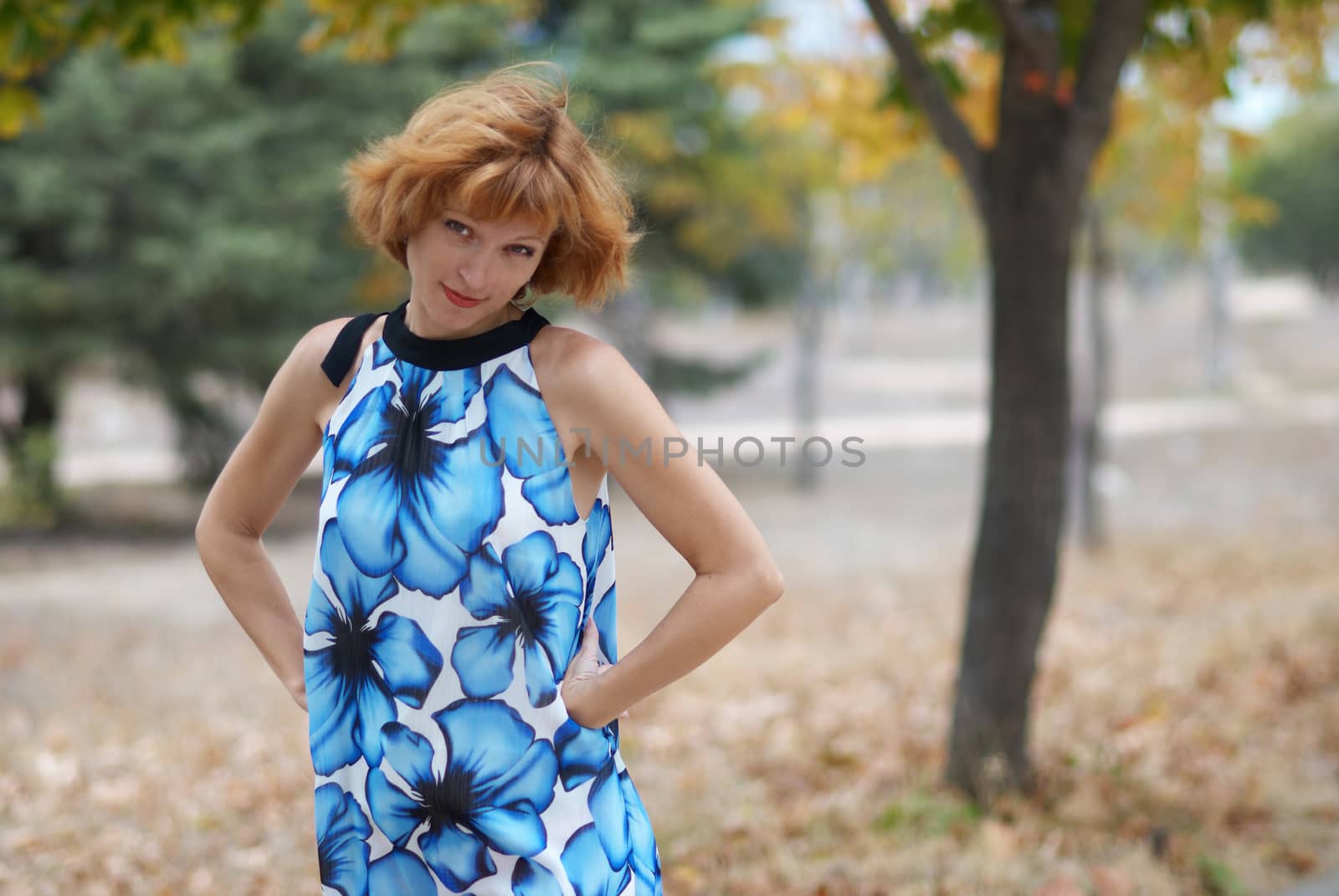 Young woman walking in autumn park, soft background