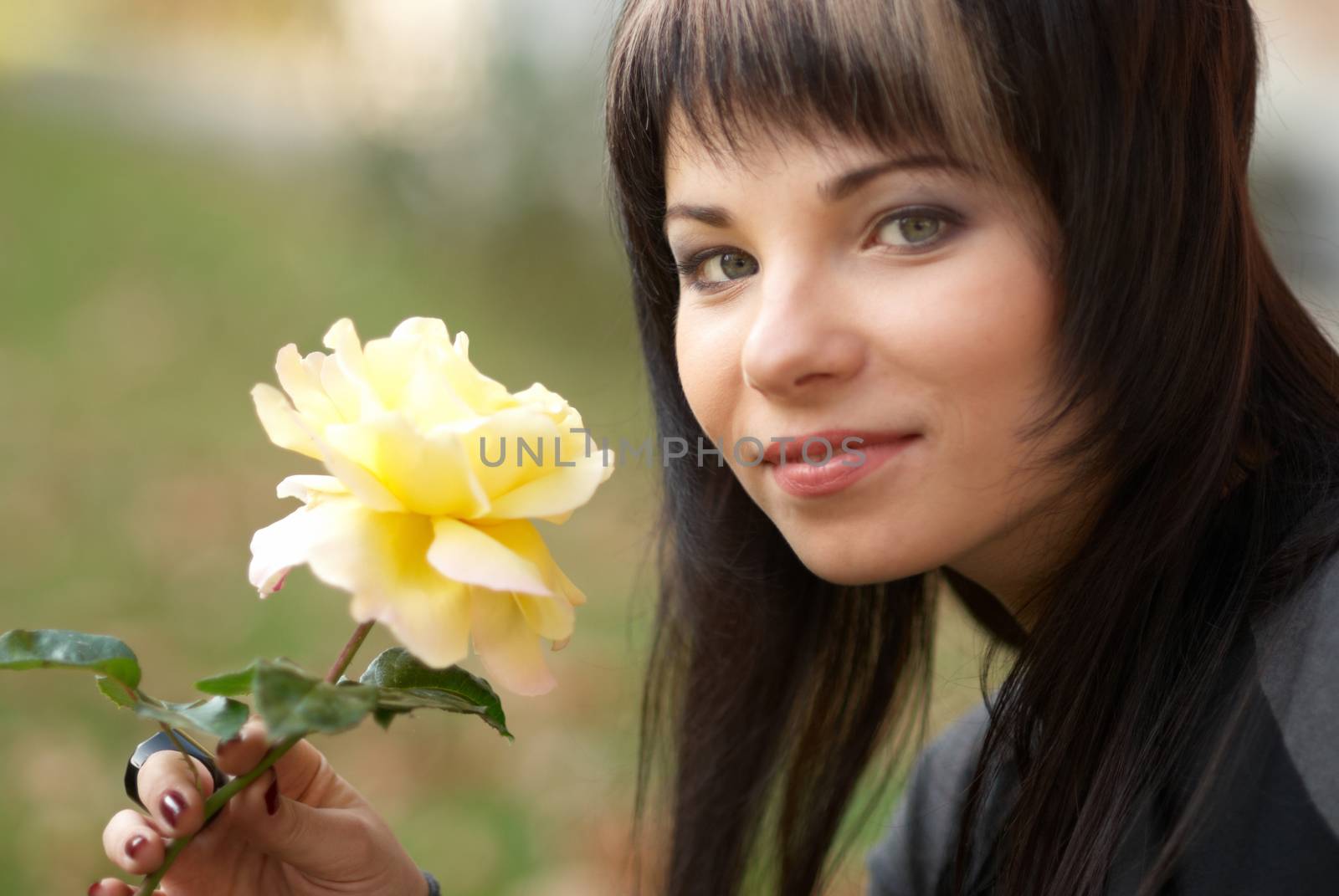 Beautiful girl with yellow rose, soft background