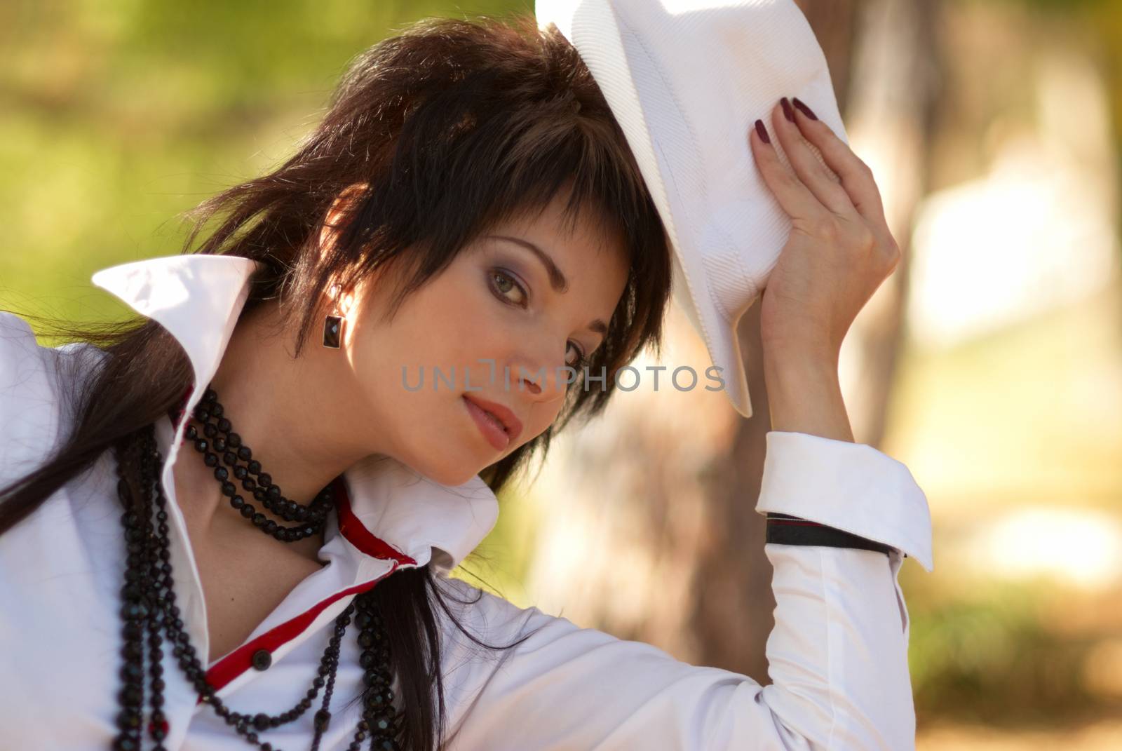 Beautiful girl in the white hat- soft background portrait