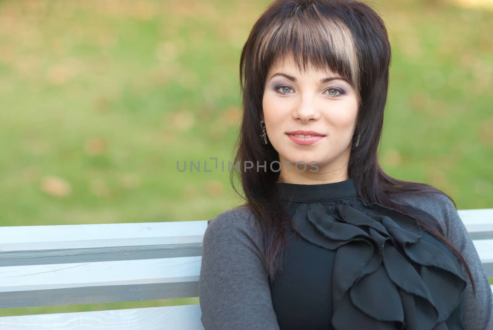 Portrait of beautiful girl sitting on the bench