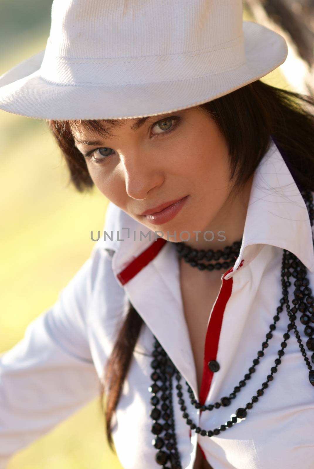 Beautiful girl in the white hat- soft background portrait