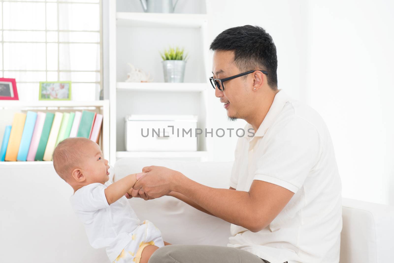 Father and baby boy playing at indoors. Southeast Asian family lifestyle at home.