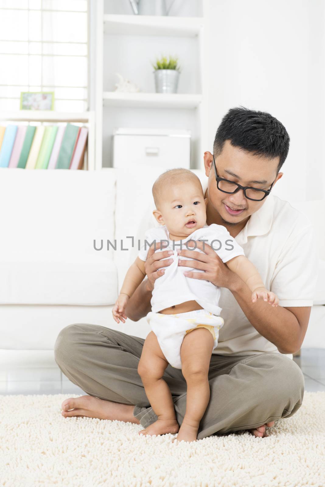 Asian father and baby playing at home.  by szefei