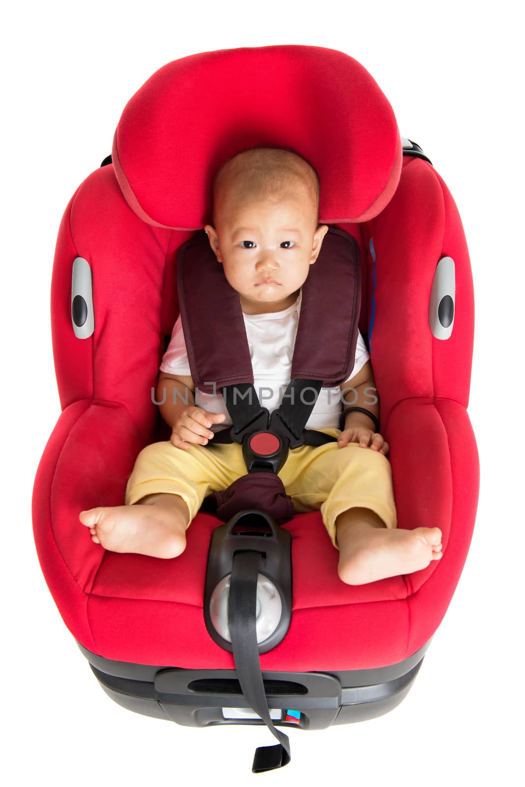 Baby boy sitting in car seat isolated by szefei