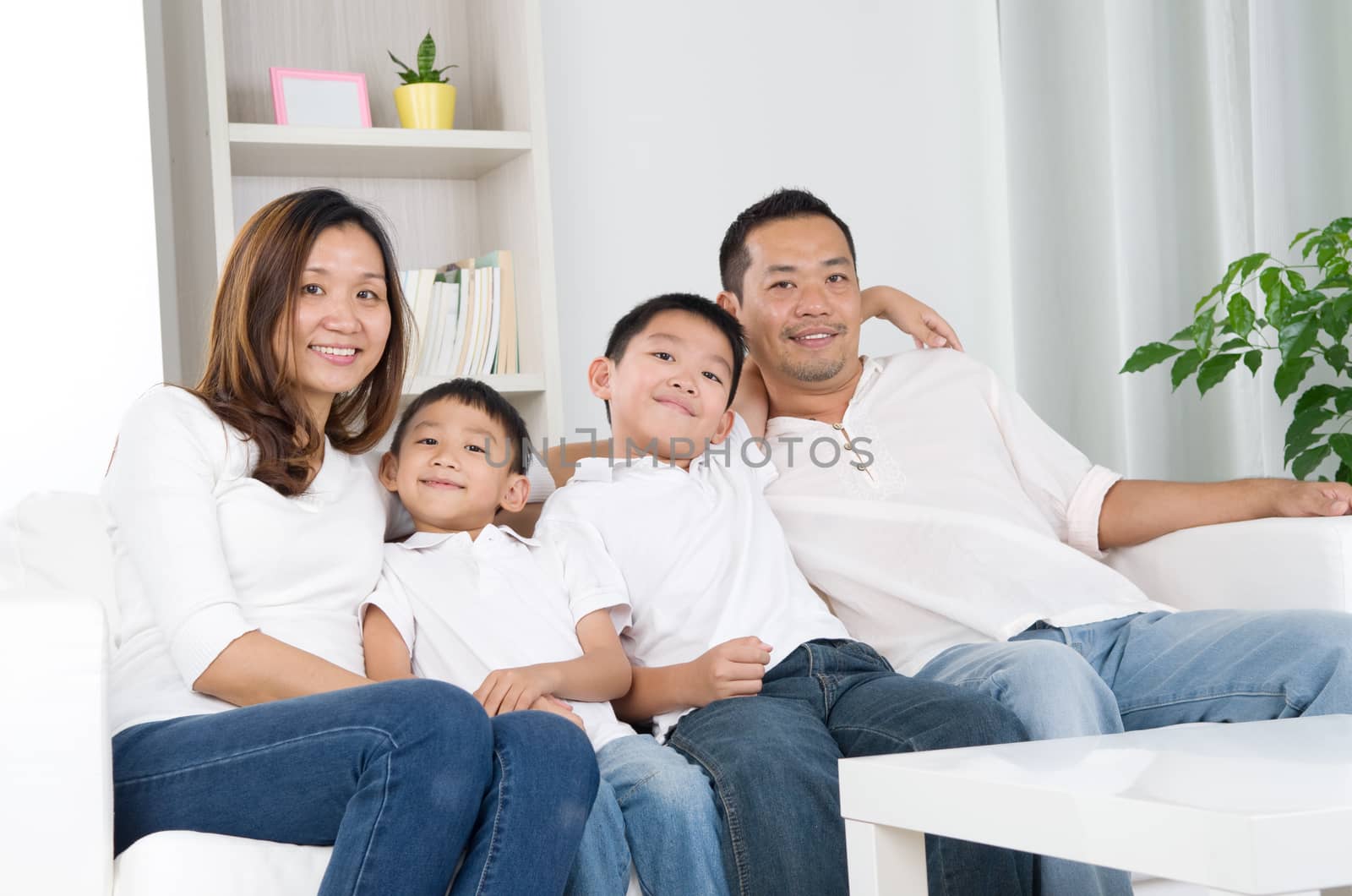 Portrait of asian family sitting on sofa