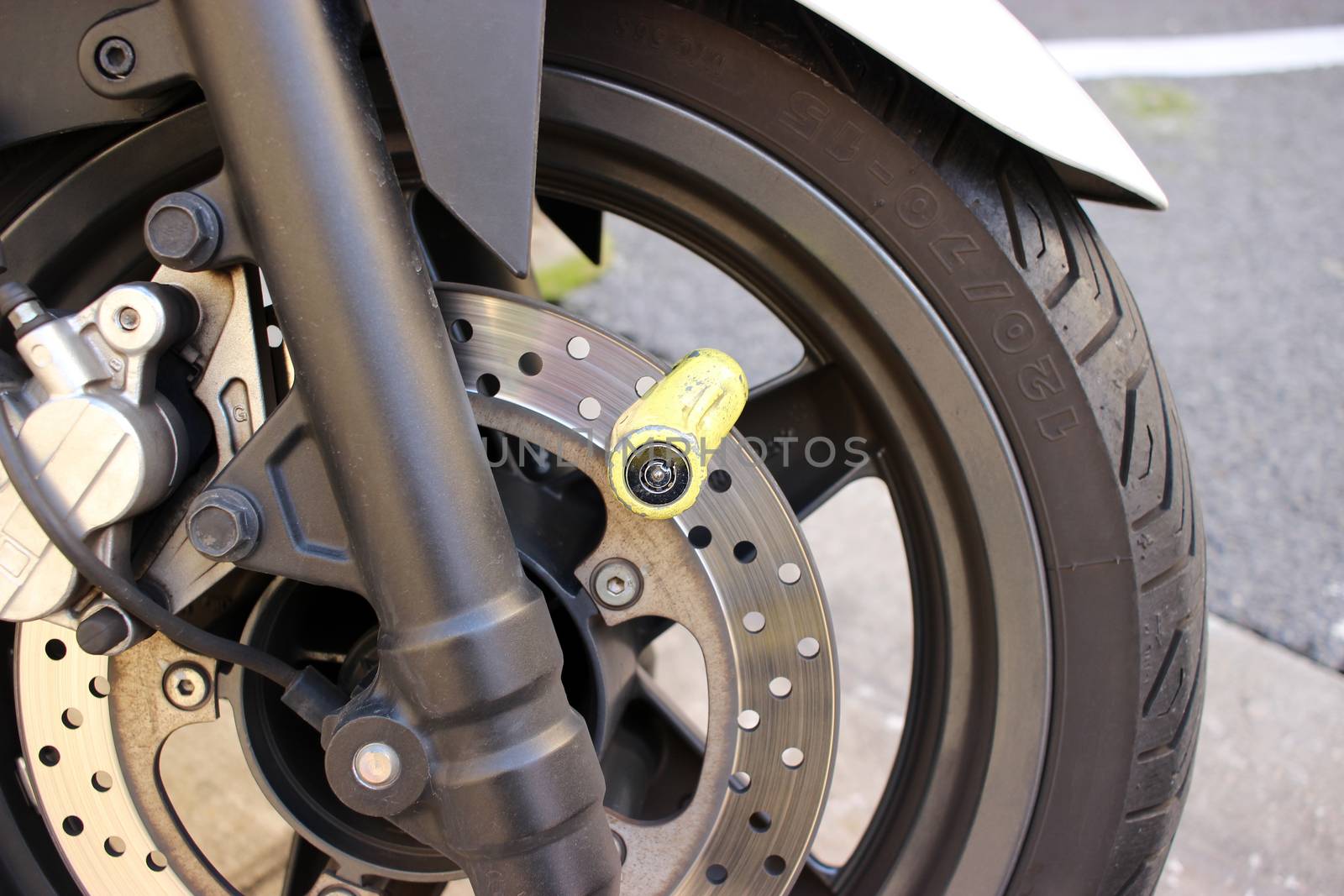 Yellow Disc Lock on Motorbike Disc Brake Close-up
