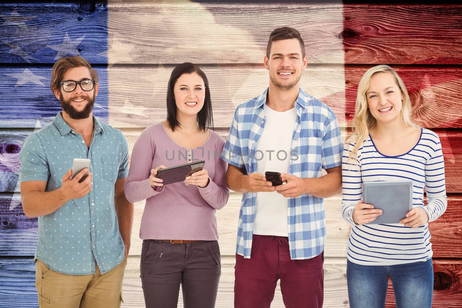 Portrait of smiling business people using electronic gadgets  against composite image of usa national flag