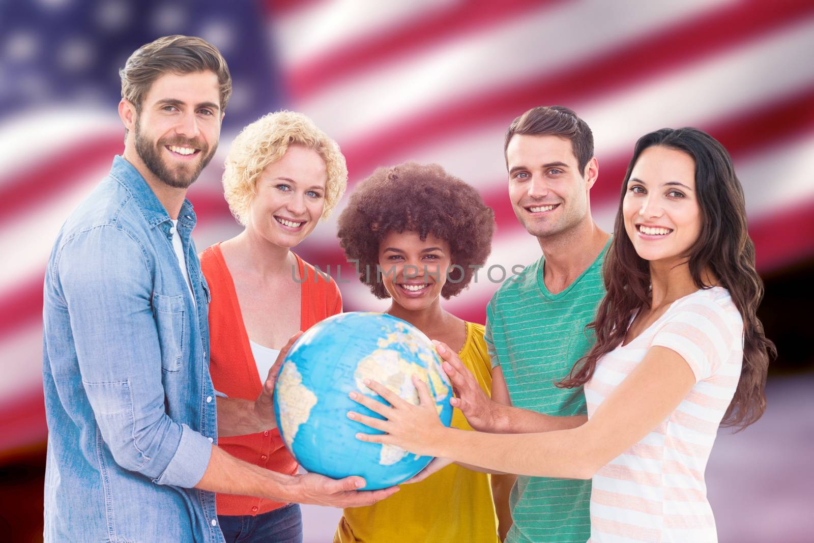 Young creative business people with a globe  against composite image of digitally generated united states national flag