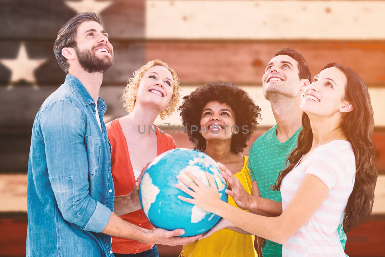 Young creative business people with a globe  against composite image of usa national flag