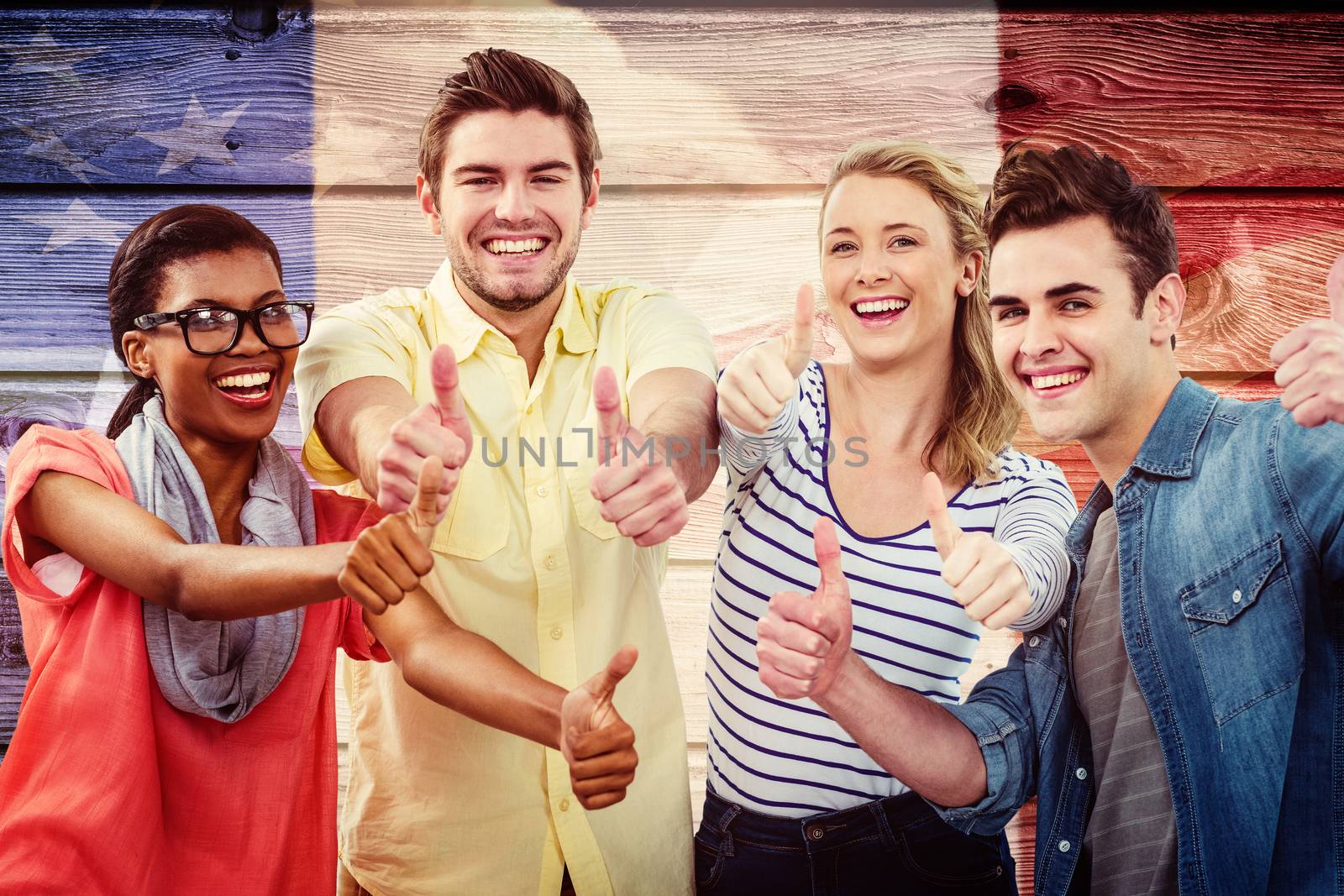Happy creative team giving the thumbs up against composite image of usa national flag