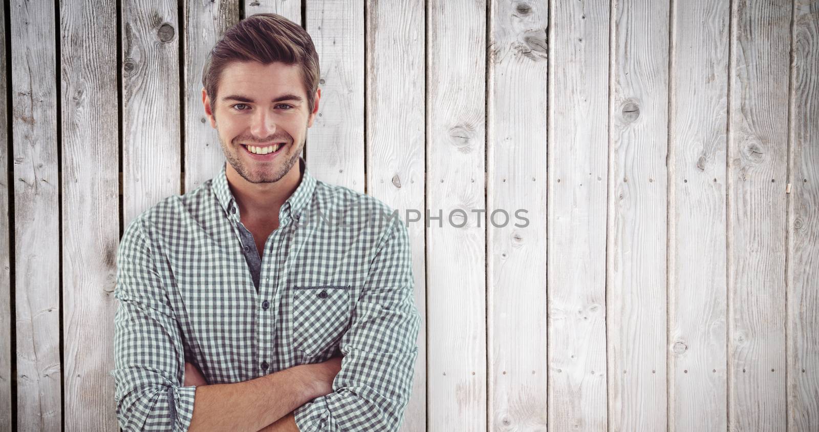 Smiling crestive business man against wooden planks
