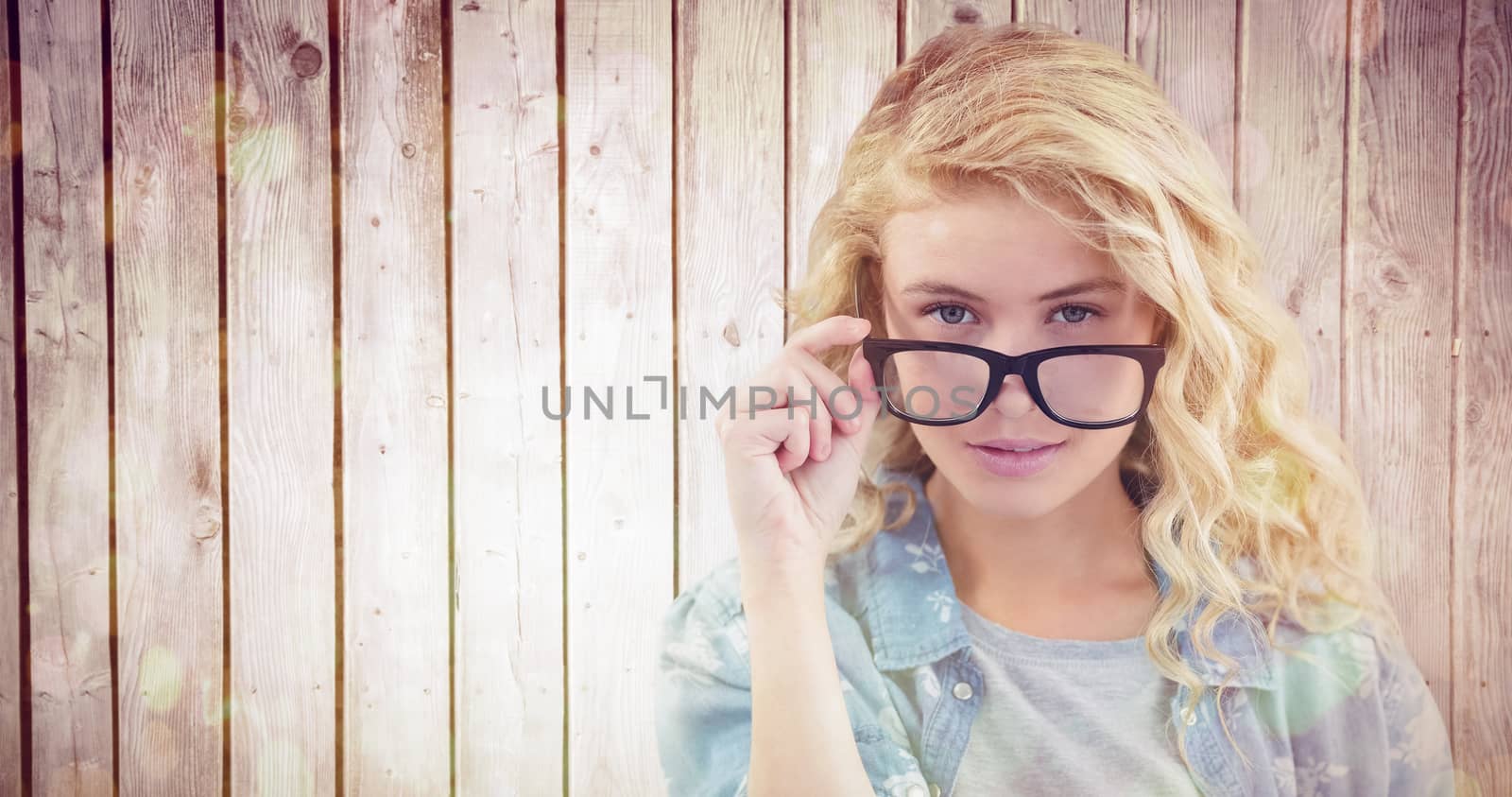 Composite image of portrait of businesswoman wearing eyeglasses posing  by Wavebreakmedia