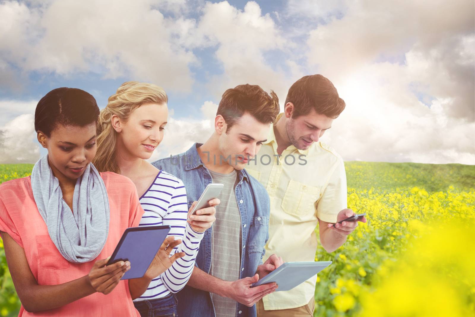 Composite image of smiling creative team standing in a line using technology by Wavebreakmedia