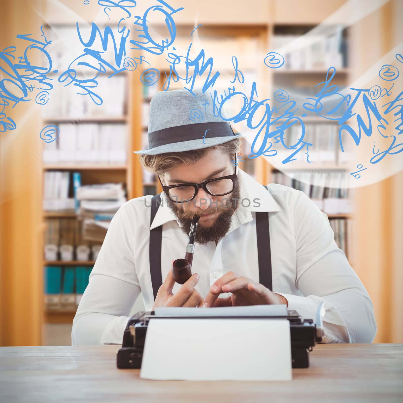 Hipster smoking pipe while working at desk against library