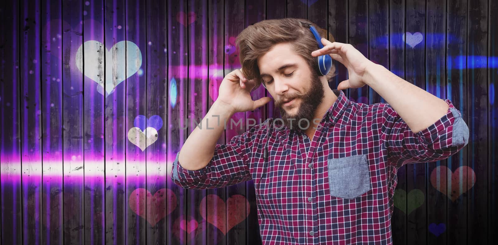 Hipster wearing headphones against wooden planks background
