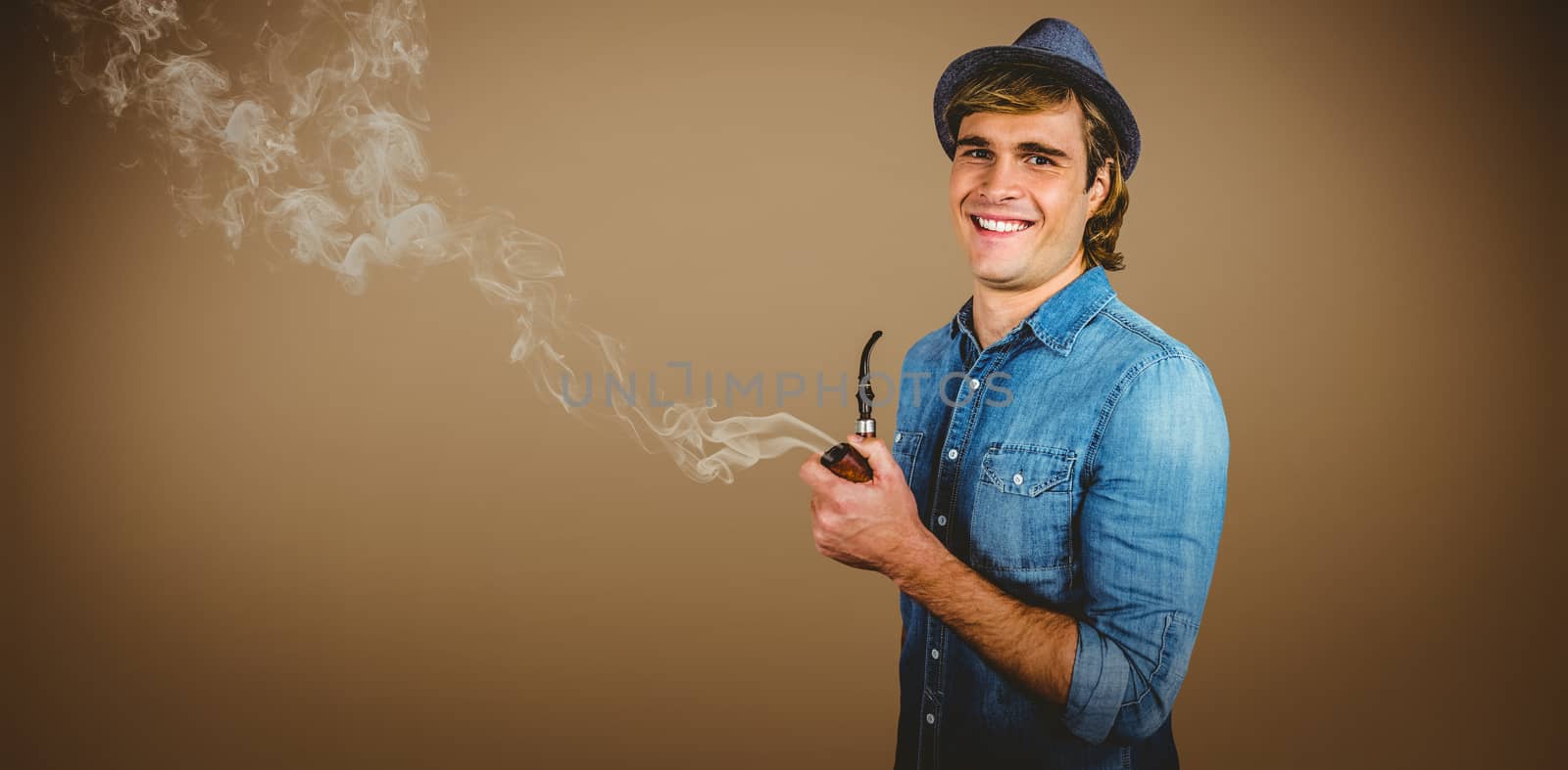 Cheerful hipster holding pipe against grey background with vignette