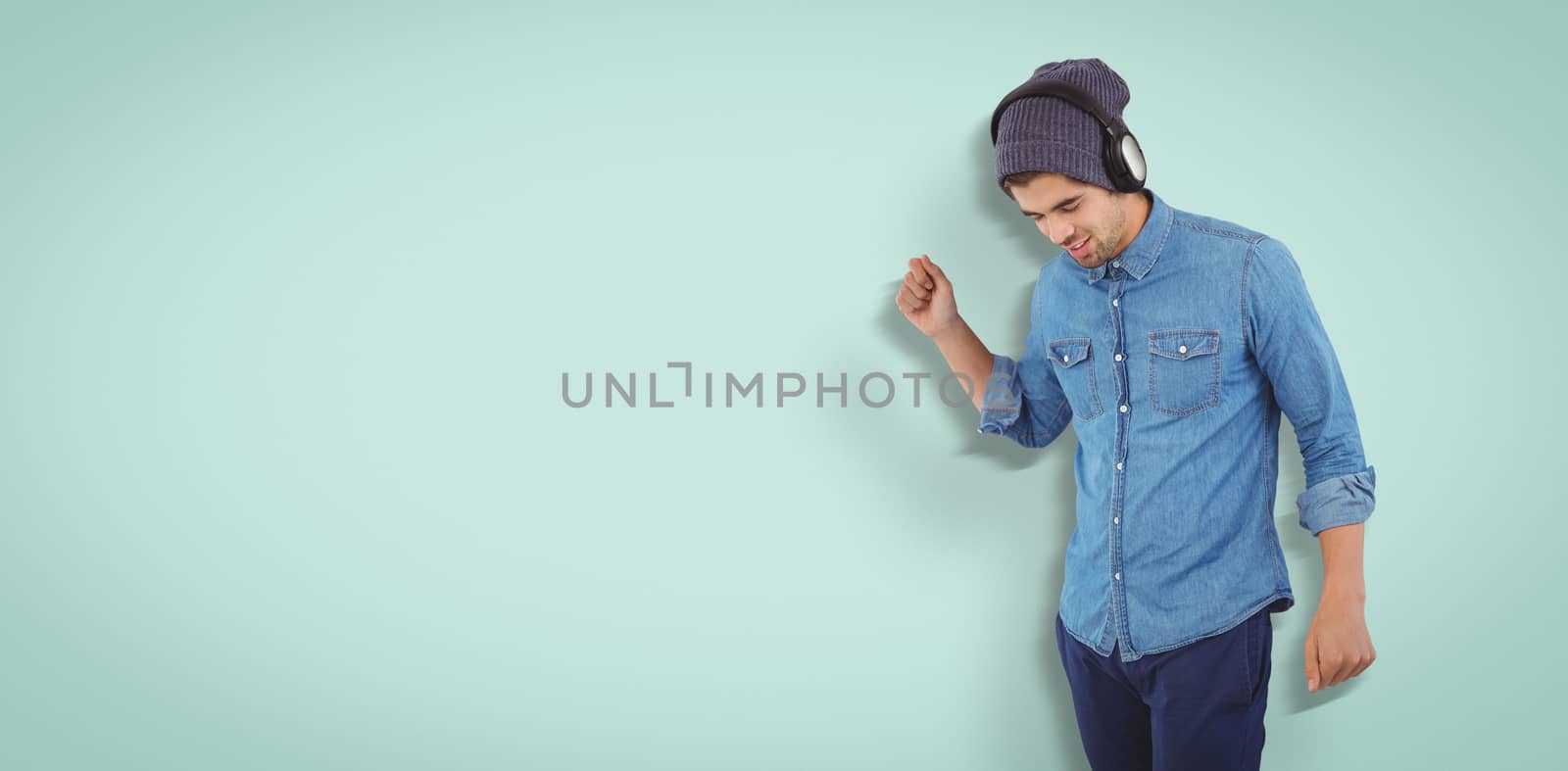 Hipster wearing headphones enjoying music against blue vignette background