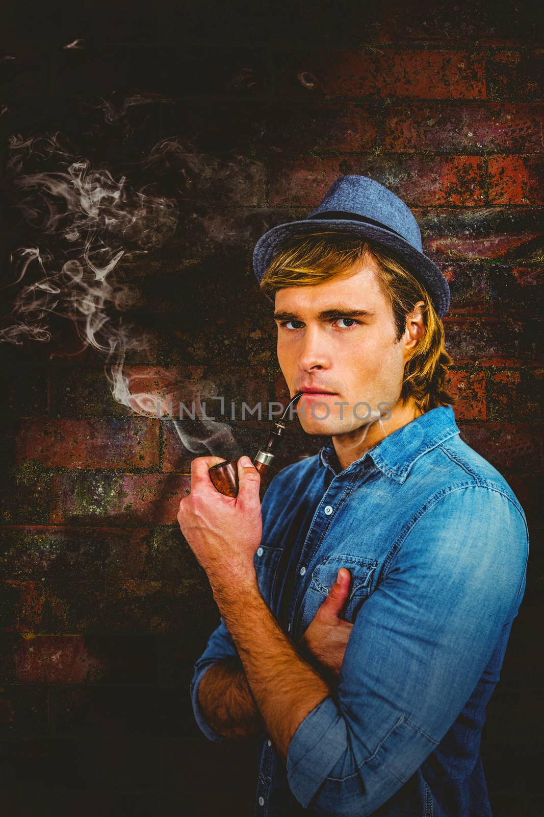 Composite image of serious hipster smoking pipe by Wavebreakmedia