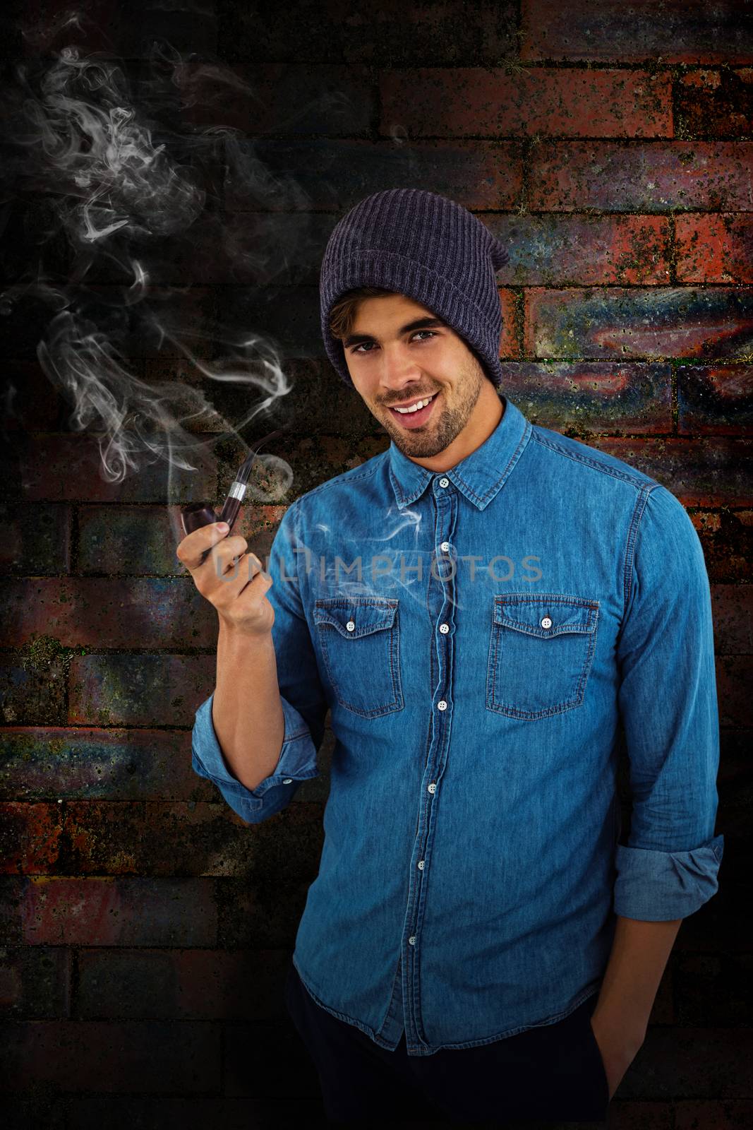 Composite image of portrait of hipster smiling while holding smoking pipe by Wavebreakmedia