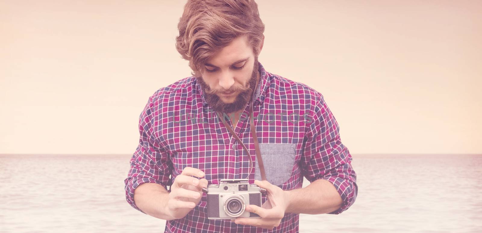 Composite image of hipster using camera by Wavebreakmedia