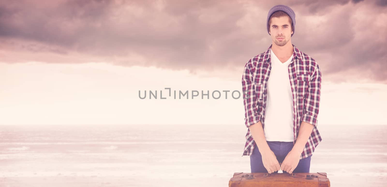 Portrait of confident man holding bag against cloudy landscape background