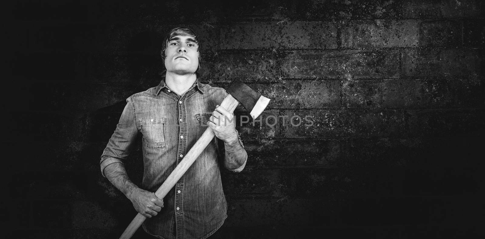 Composite image of front view of hipster standing with axe by Wavebreakmedia