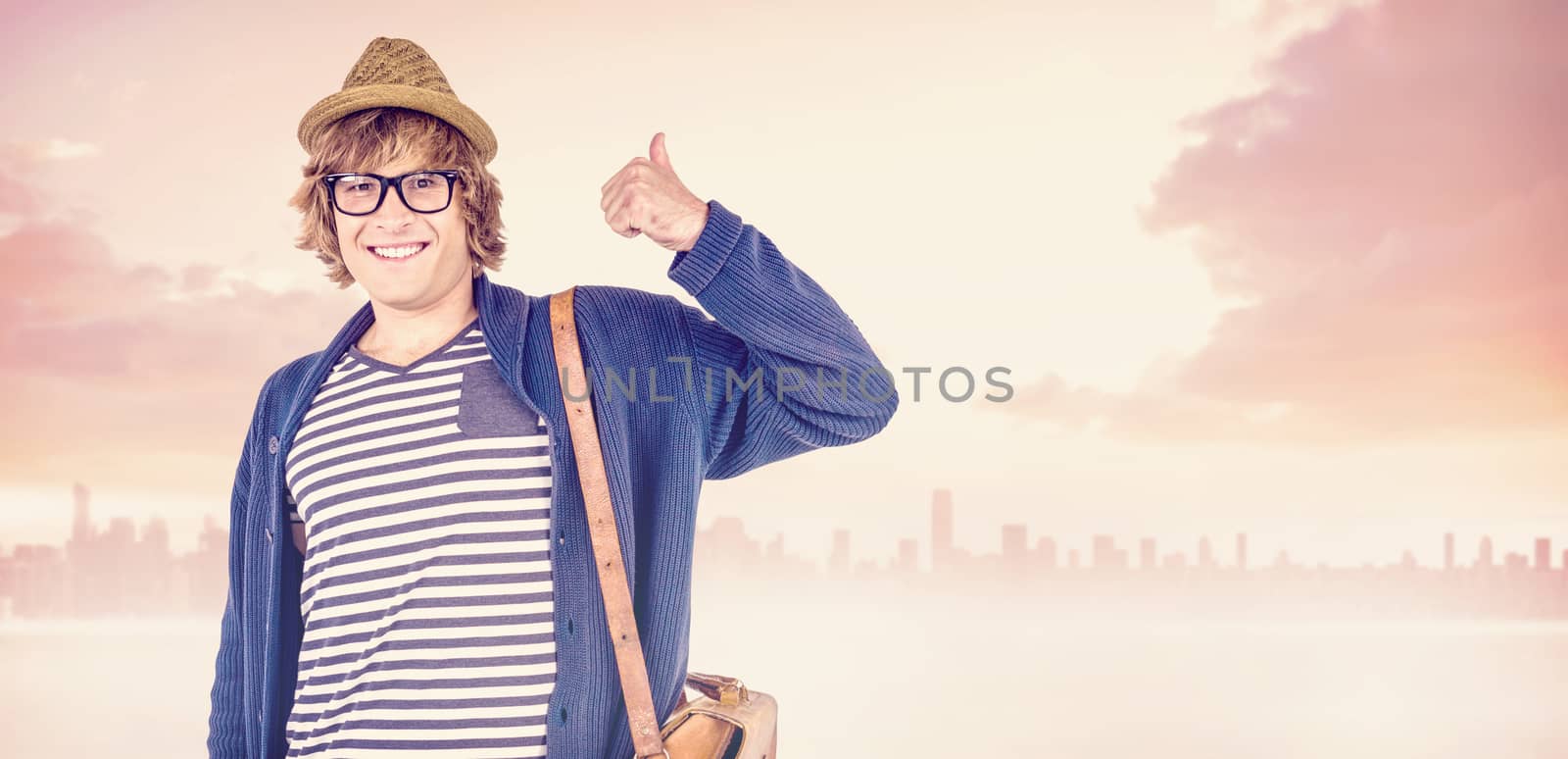 Smiling hipster making thumbs up against cityscape on the horizon