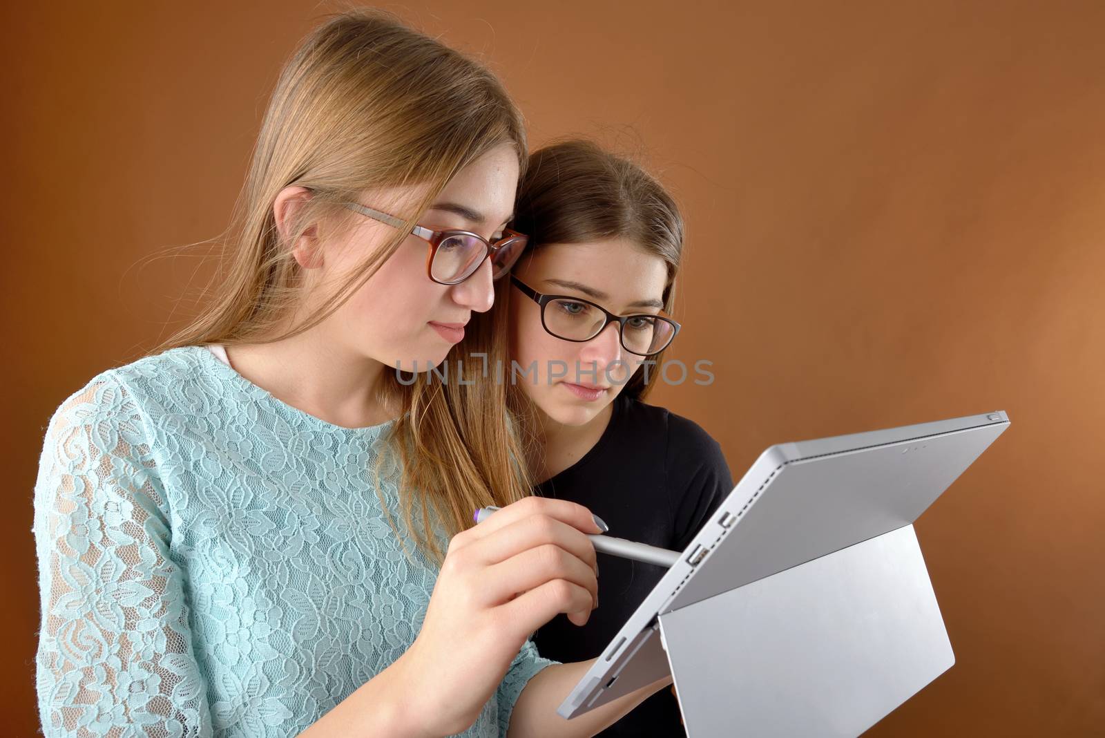 two young teenage girls with a tablet by mady70