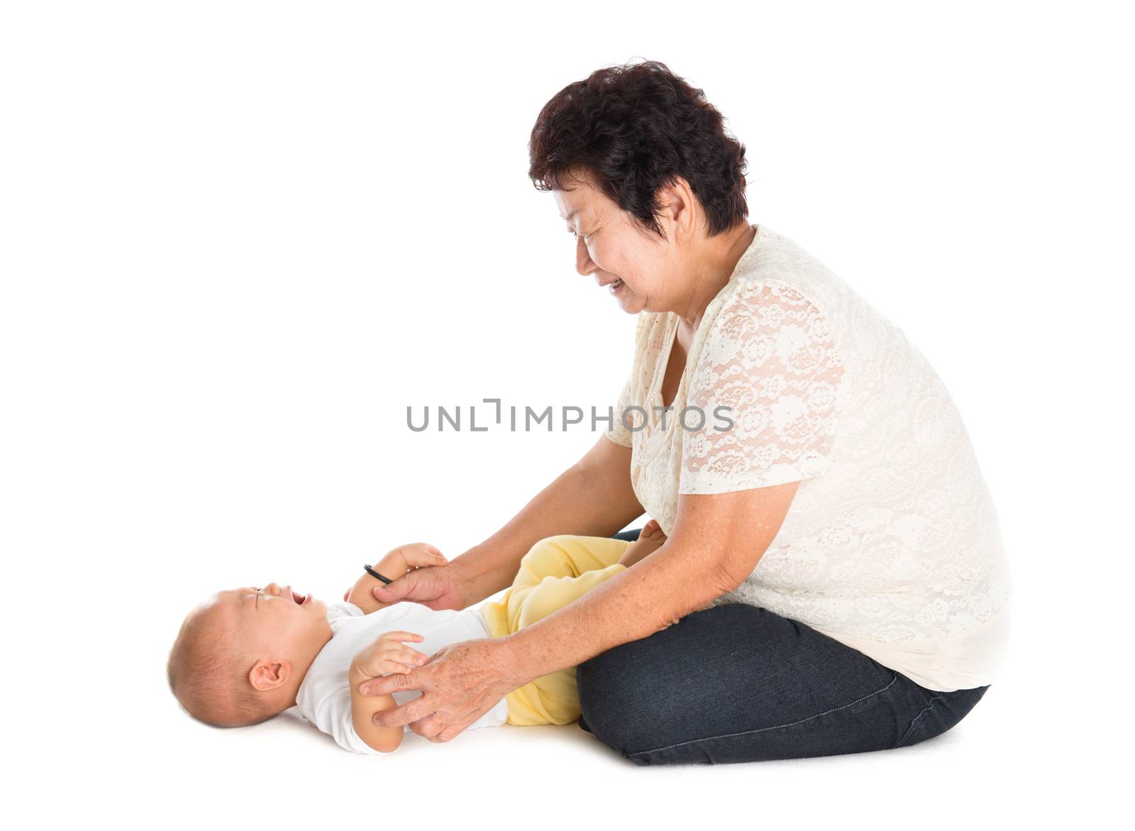 Grandmother comforting crying grandson. Isolated on white background.