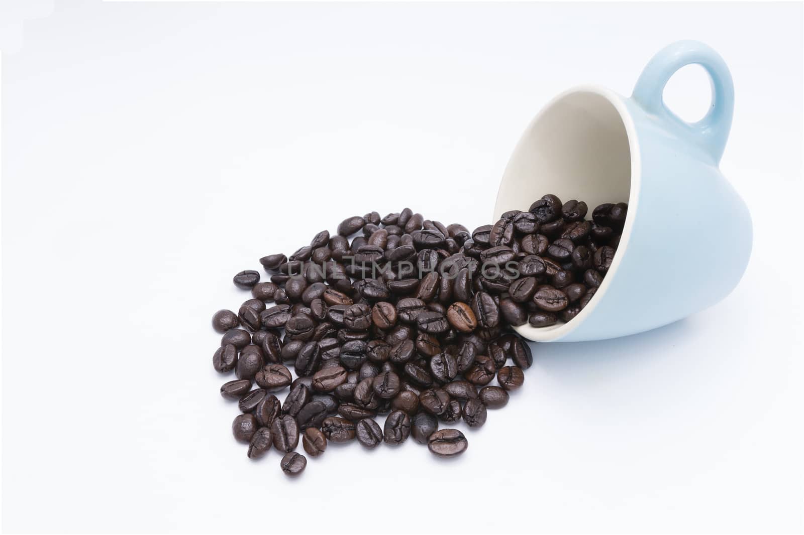 Coffee beans in coffee cup isolated on white