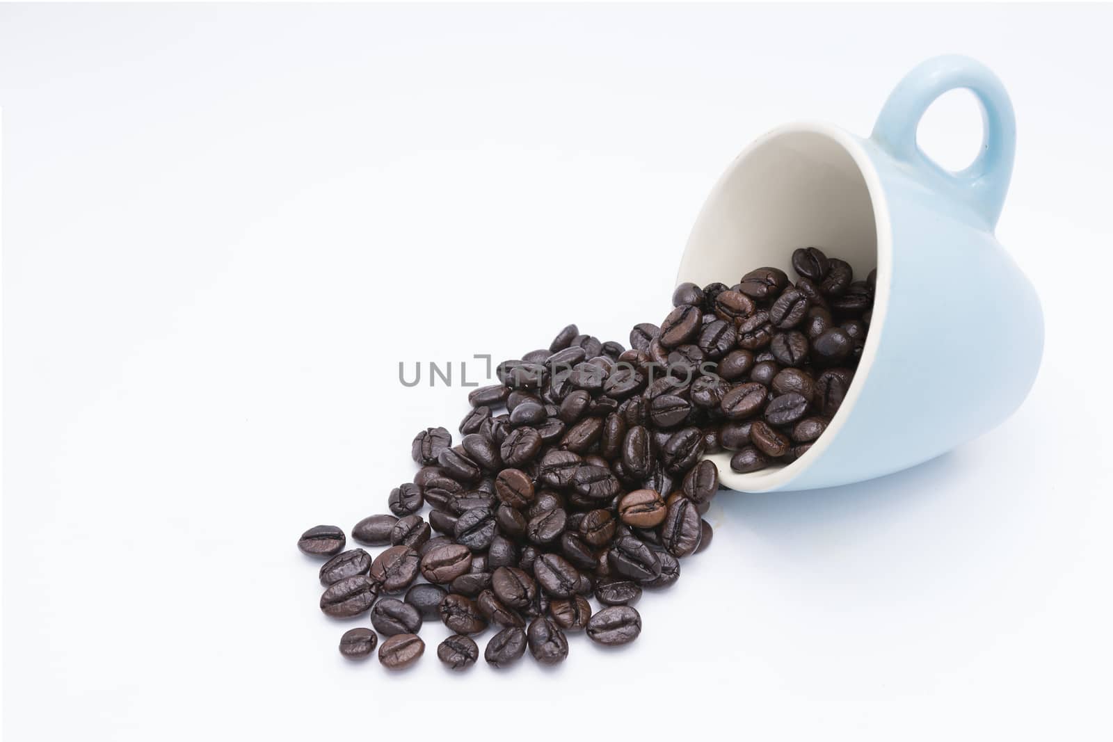 Coffee beans in coffee cup isolated on white