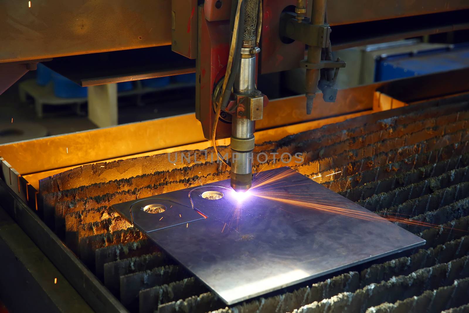 Industrial cnc plasma cutting of metal plate. Closeup by sergasx