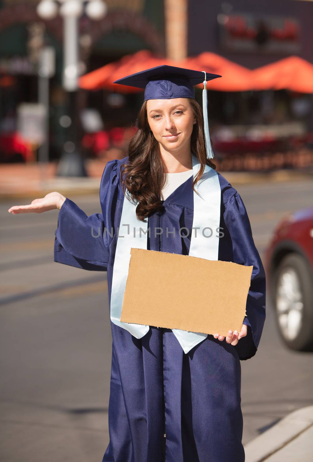 Grinning woman with hand out holding cardboard sign