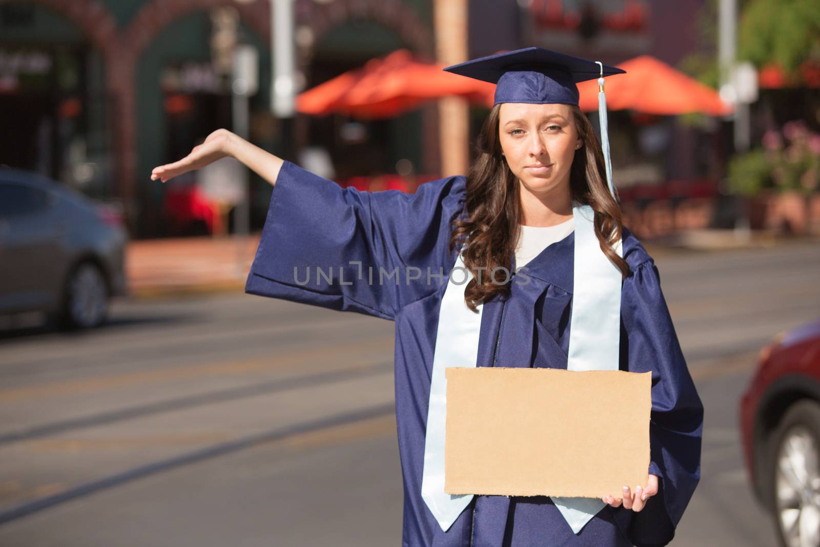 Serious female student holding hand out with cardboard sign