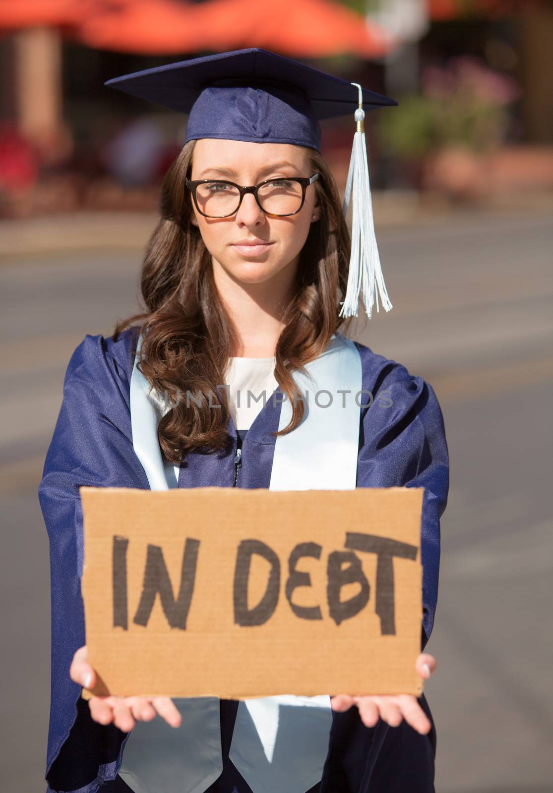 Single young adult holding a cardboard in debt sign
