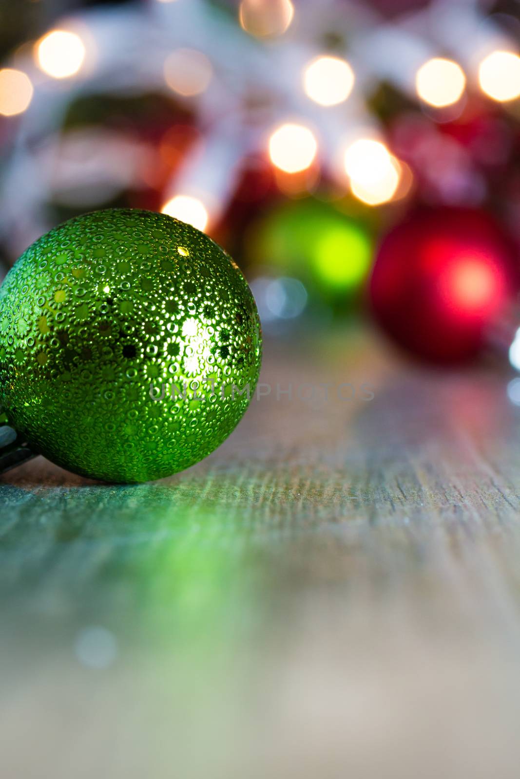 Colorful Christmas ornaments and lights on a wooden background.