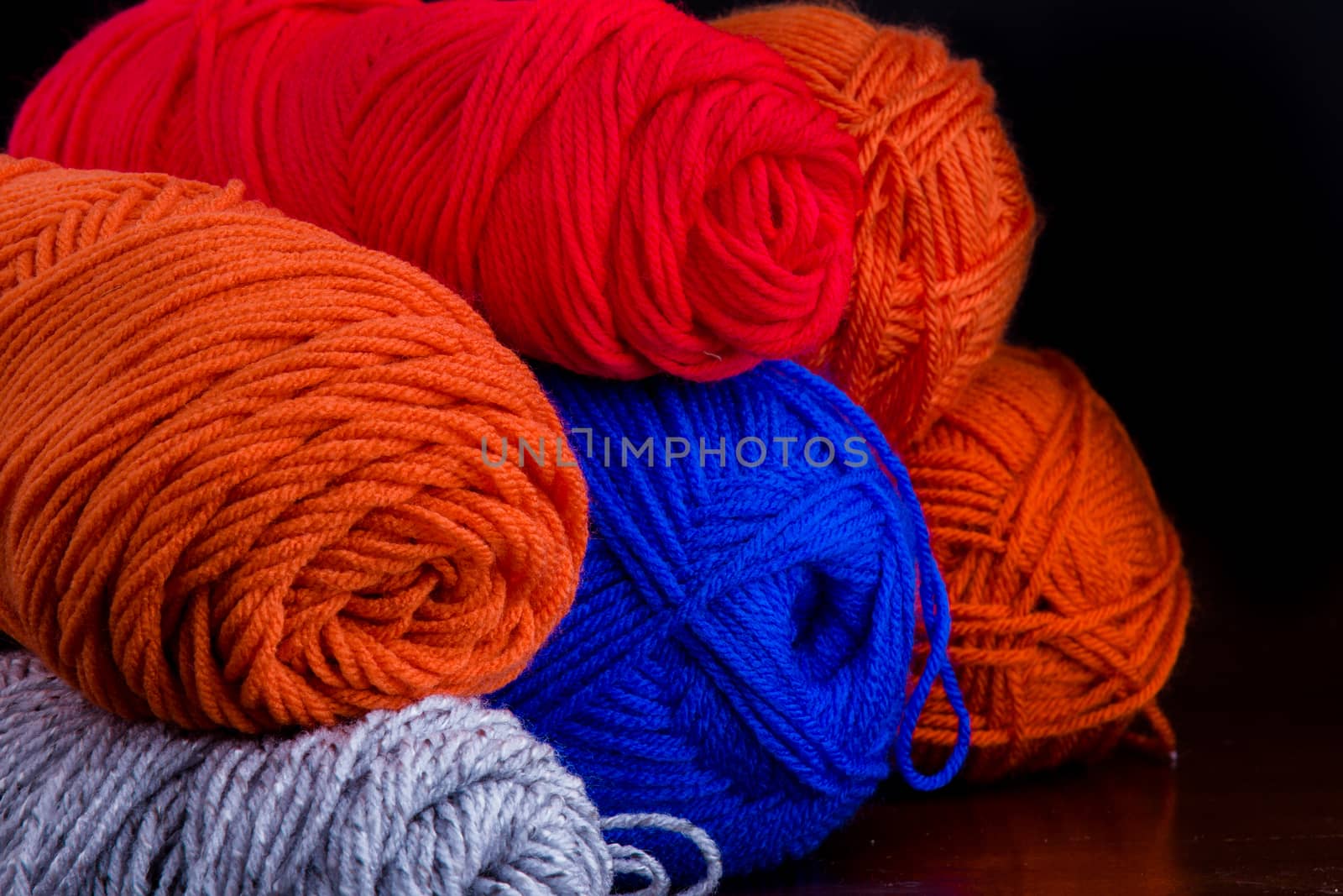 Yarn that is sitting in buddles waiting for someone to use them for homemade goods.