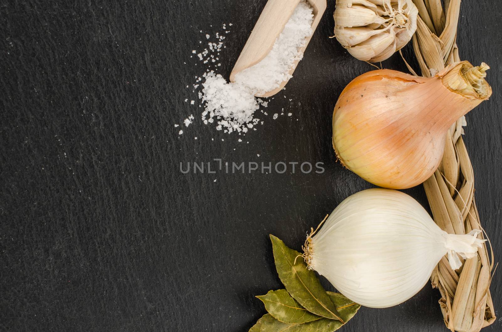 The head of garlic, onions, salt on chalkboard