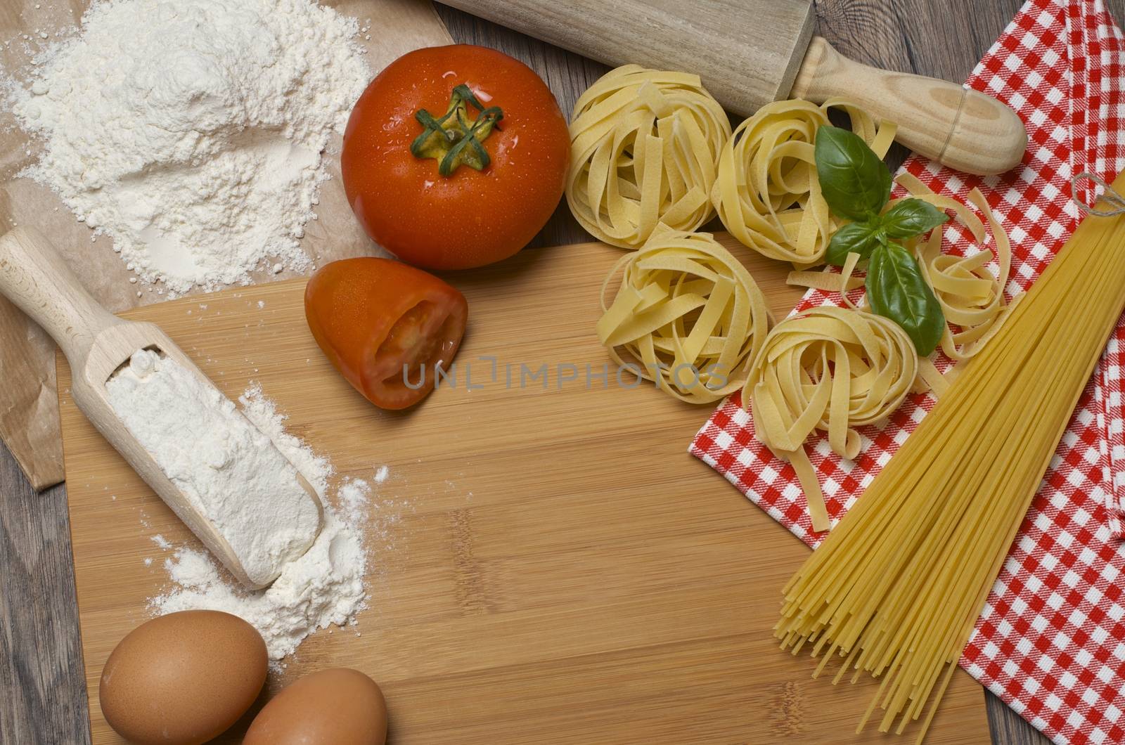 Still life with raw homemade pasta and ingredients for pasta