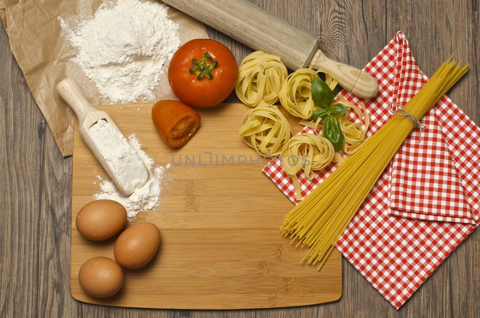 Still life with raw homemade pasta and ingredients for pasta